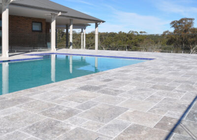 silver travertine tiles and pavers around pool sydney